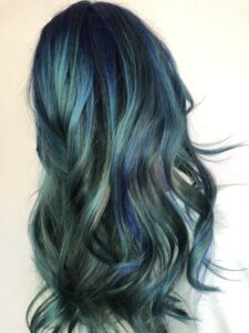 woman with long blue hair with curls